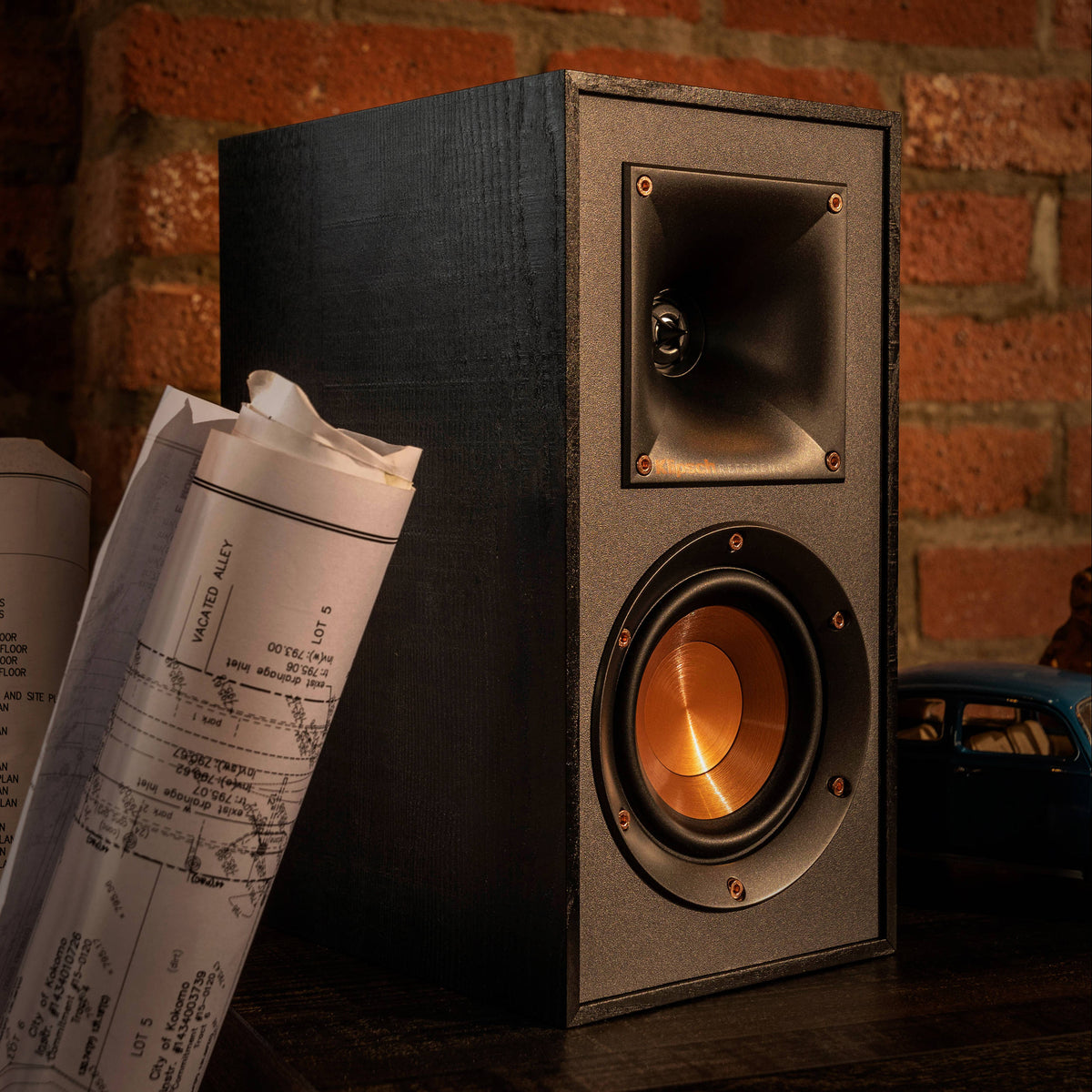 Klipsch R-51PM active bookshelf speakers with black finish and front-facing controls, designed for high-quality audio playback.