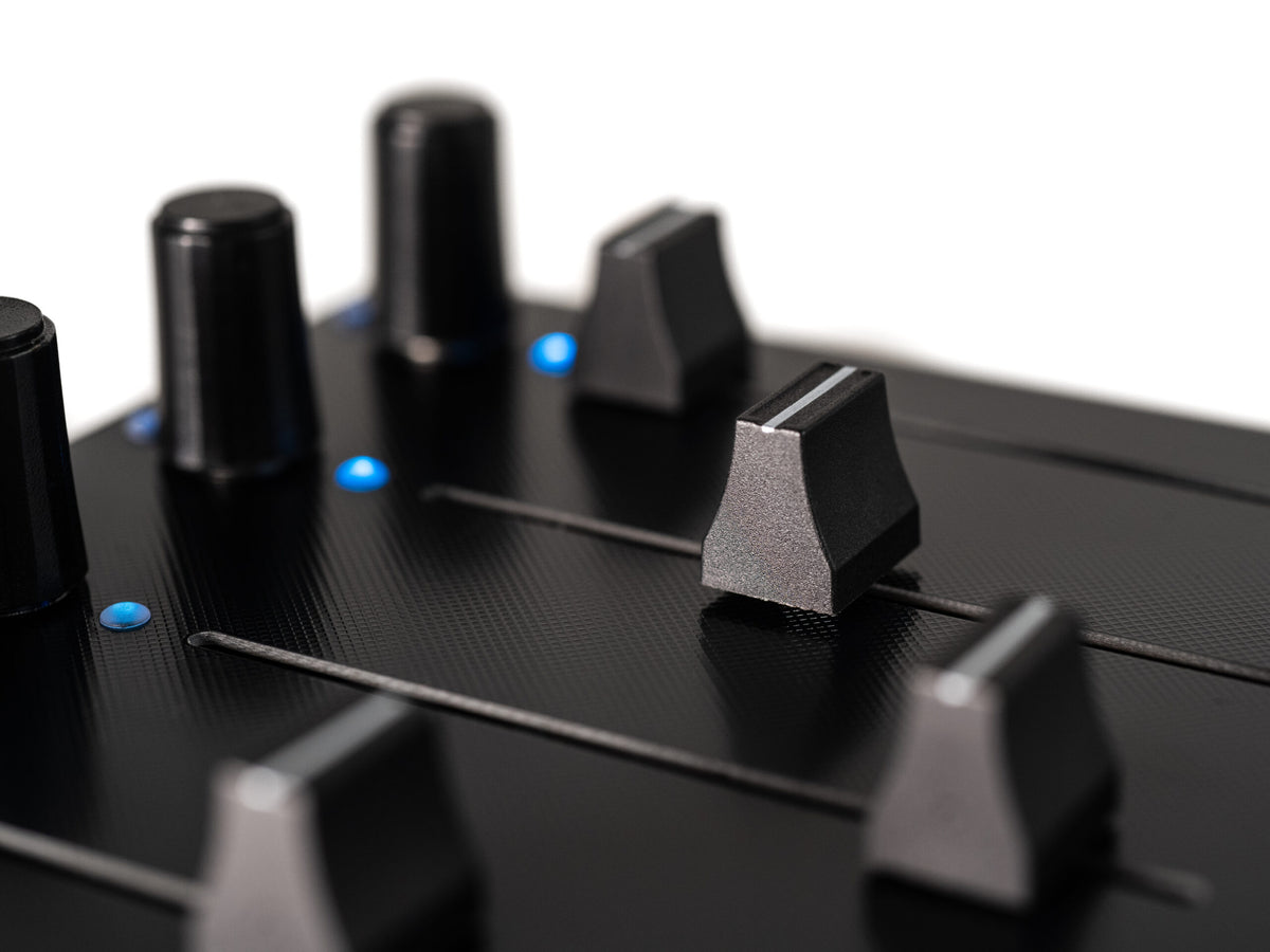 Close-up of Intech Studio EF44 Detent Series 3 MIDI controller with knobs and buttons, showing detailed control surface.