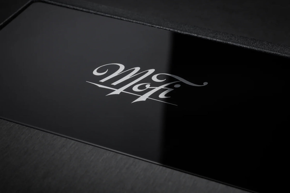 Close-up of MoFi Electronics UltraPhono phono preamp showing input and control knobs on a sleek black device.